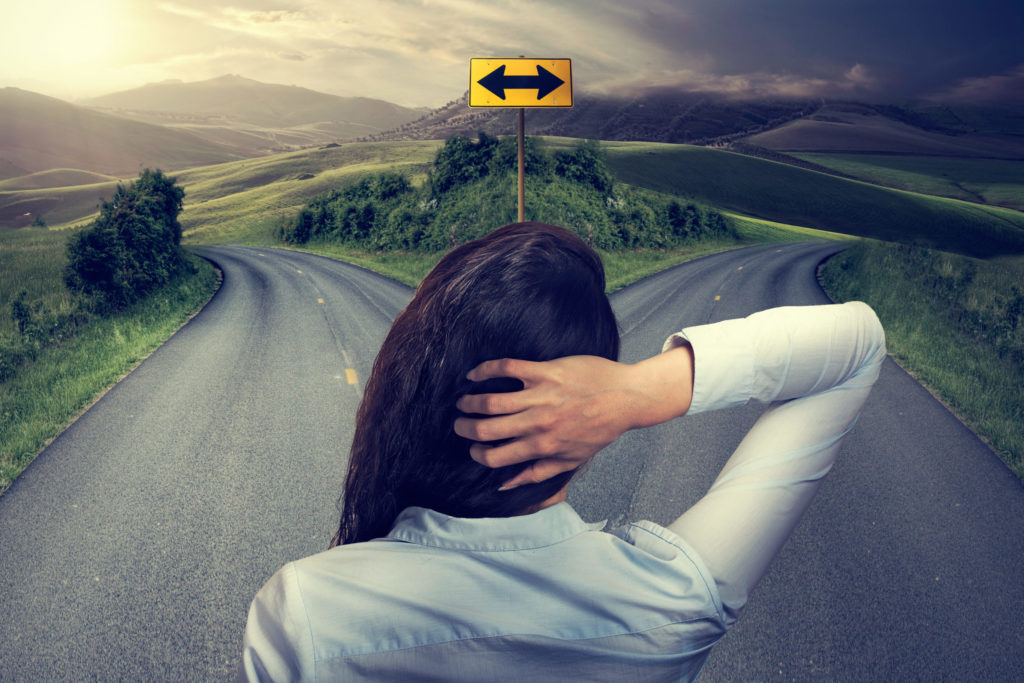 woman stands at crossroads