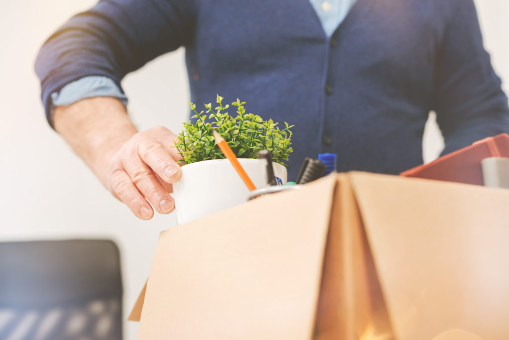 person packs their personal belongings from office