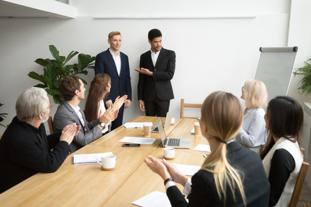 professional introduces a new team member to the office